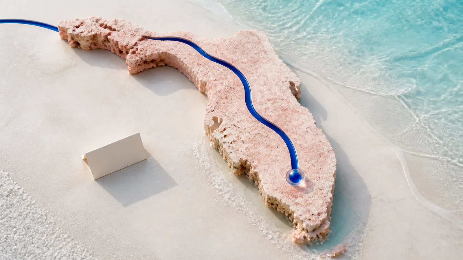 A cobalt route crossing an abstract coral-stone Florida peninsula and ending at a clear glass node