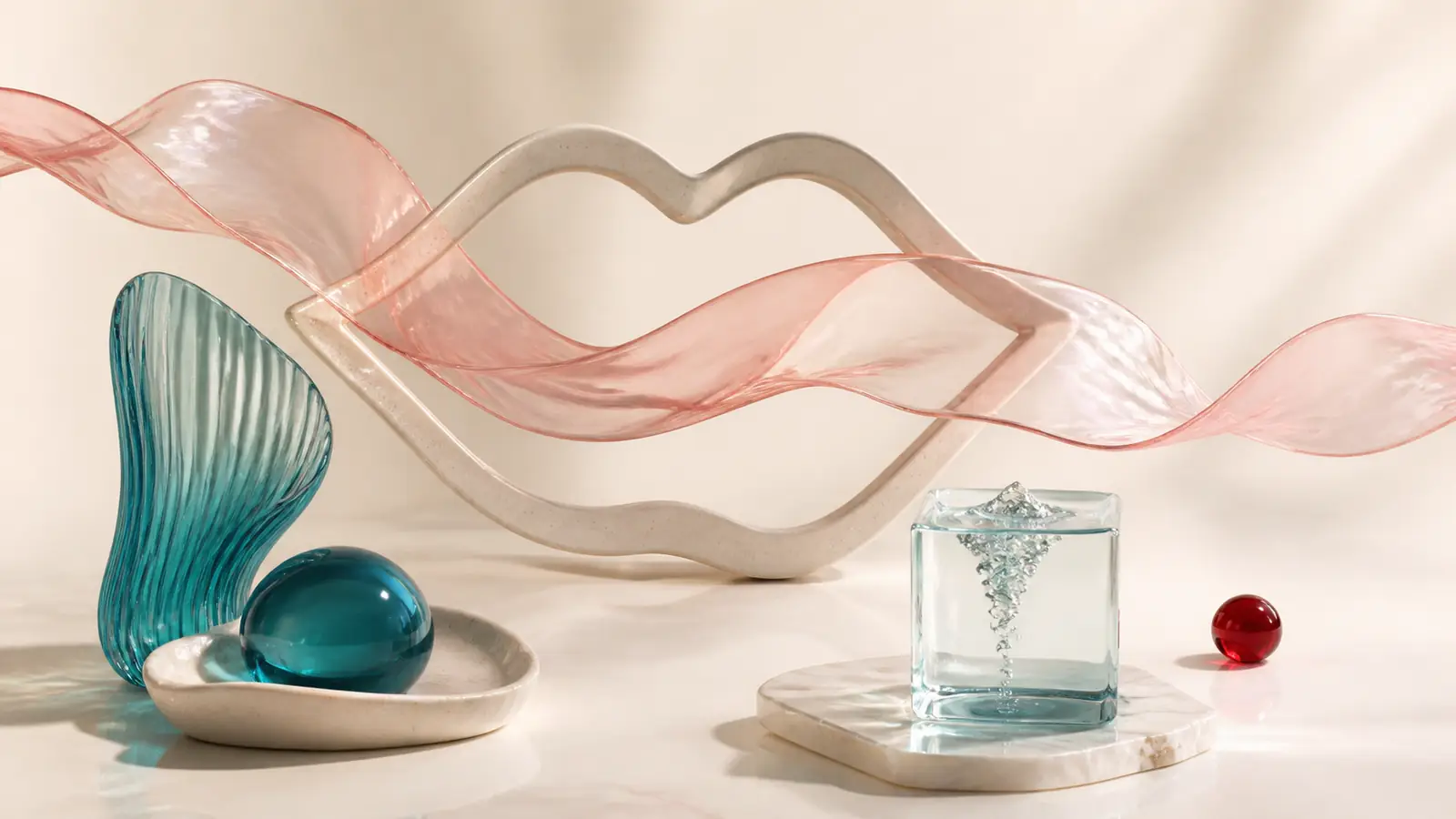 Rose glass ribbon crossing an abstract lip contour beside a clear dissolving prism