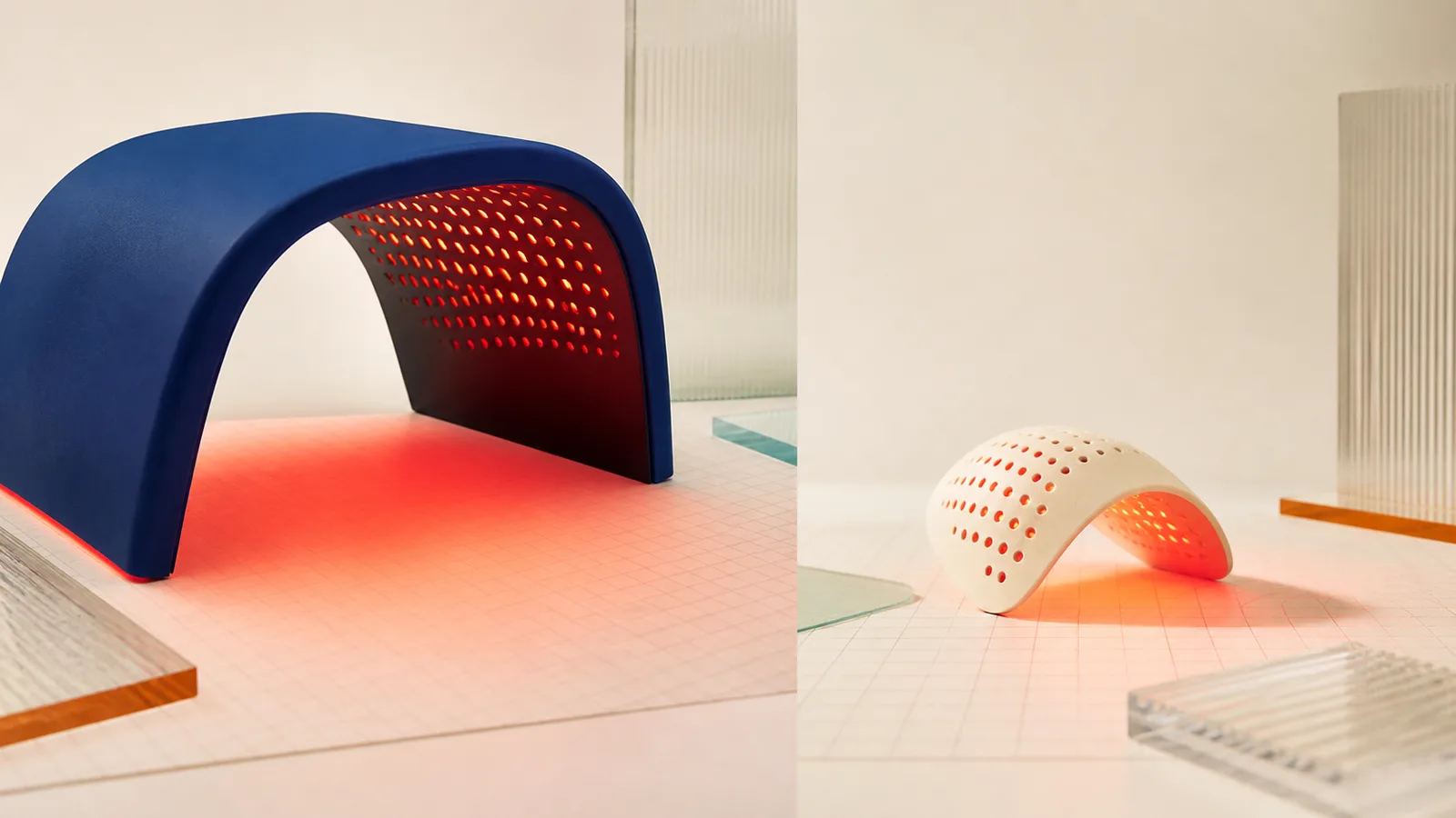 Large cobalt light arch and smaller curved light form on calibrated studio surfaces